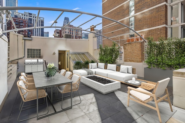 77 E Division St Unit 3, Chicago, IL 60610 - view of patio featuring a view of city, an outdoor living space with a fire pit, and outdoor dining area