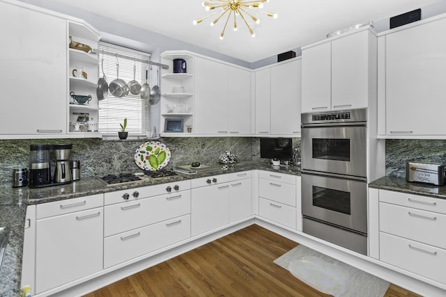 77 E Division St Unit 3, Chicago, IL 60610 - kitchen with open shelves, appliances with stainless steel finishes, white cabinets, and a chandelier