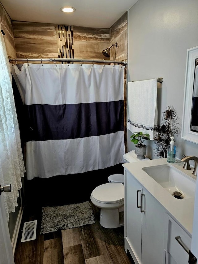 121 N Governor St, Sycamore, IL 60178 - full bathroom featuring vanity, wood finished floors, recessed lighting, and shower / bath combo
