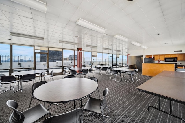 5455 N Sheridan Rd Unit 3804, Chicago, IL 60640 - dining room featuring a wall of windows, carpet, plenty of natural light, and a view of city