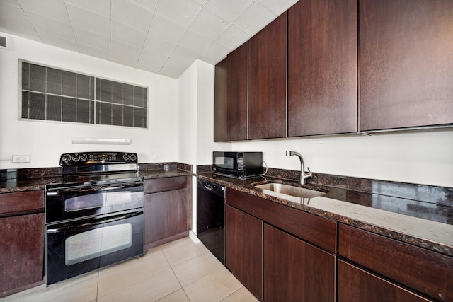 5455 N Sheridan Rd Unit 3804, Chicago, IL 60640 - kitchen featuring black appliances, dark stone countertops, dark brown cabinetry, and light tile patterned floors