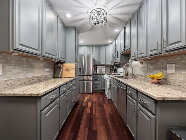 655 Charing Cross Rd, Elk Grove Village, IL 60007 - kitchen with gray cabinetry, stainless steel appliances, dark wood-style flooring, decorative backsplash, and light stone countertops