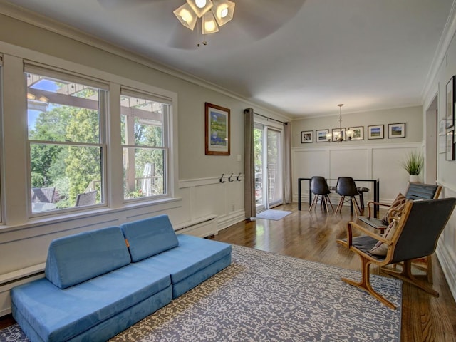 415 N Taylor Ave, Oak Park, IL 60302 - living area with a decorative wall, a chandelier, dark wood finished floors, a baseboard radiator, and crown molding
