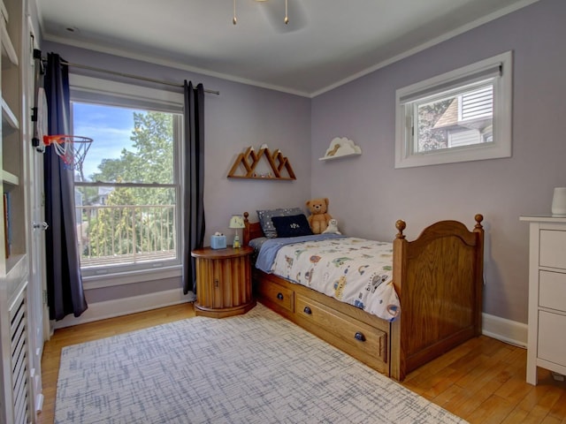 415 N Taylor Ave, Oak Park, IL 60302 - bedroom featuring crown molding, light wood-style floors, and multiple windows