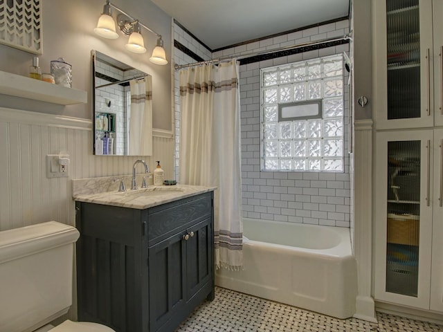 415 N Taylor Ave, Oak Park, IL 60302 - bathroom featuring a wainscoted wall, vanity, shower / bath combo, and tile patterned floors