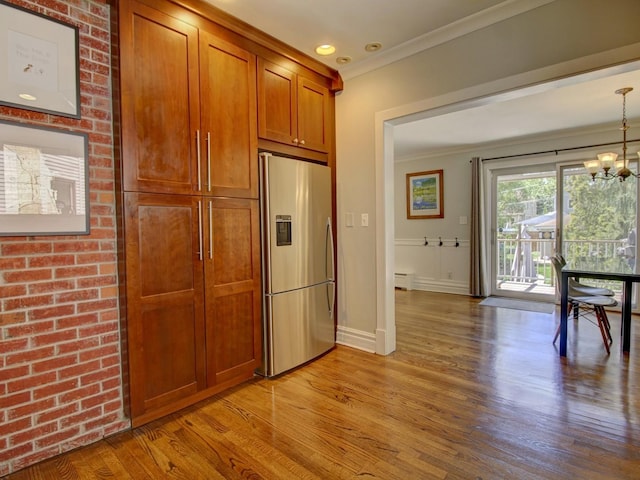 415 N Taylor Ave, Oak Park, IL 60302 - kitchen with stainless steel fridge with ice dispenser, ornamental molding, light wood finished floors, brown cabinets, and a chandelier