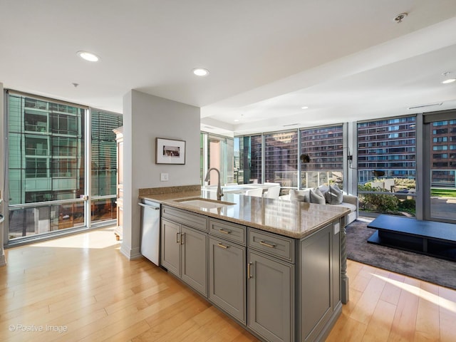 240 E Illinois St Unit 1002, Chicago, IL 60611 - kitchen featuring gray cabinets, dishwasher, expansive windows, light stone countertops, and light wood finished floors