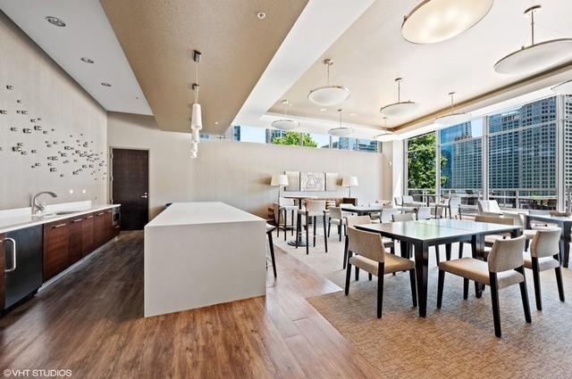 240 E Illinois St Unit 1002, Chicago, IL 60611 - dining space featuring wood finished floors