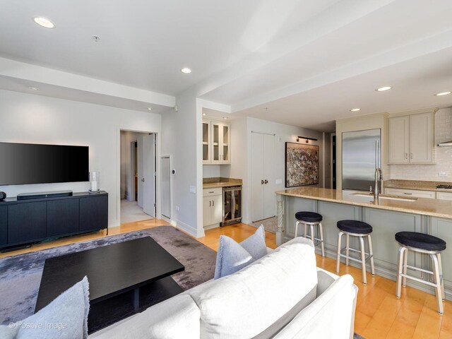 240 E Illinois St Unit 1002, Chicago, IL 60611 - living area featuring beverage cooler, light wood-style floors, and recessed lighting