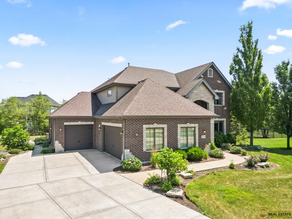 13119 Kinsale Ct, Lemont, IL 60439 - view of front of property featuring an attached garage, concrete driveway, a front lawn, and brick siding