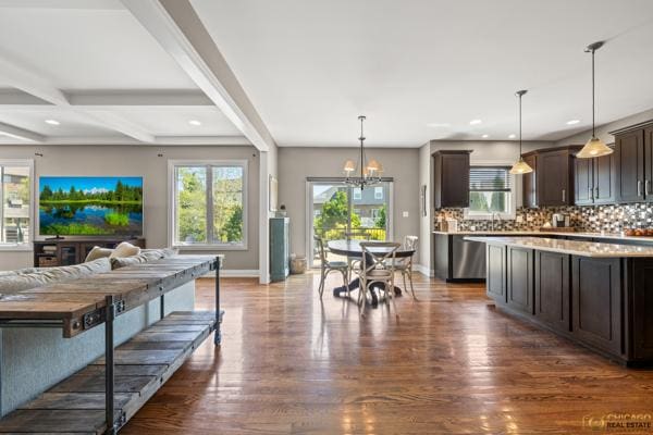 13119 Kinsale Ct, Lemont, IL 60439 - kitchen with dark brown cabinetry, open floor plan, light countertops, stainless steel dishwasher, and decorative backsplash