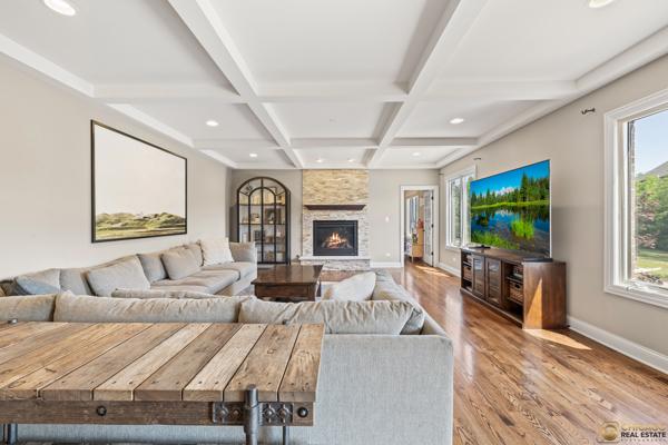 13119 Kinsale Ct, Lemont, IL 60439 - living area featuring wood finished floors, a stone fireplace, recessed lighting, beamed ceiling, and coffered ceiling