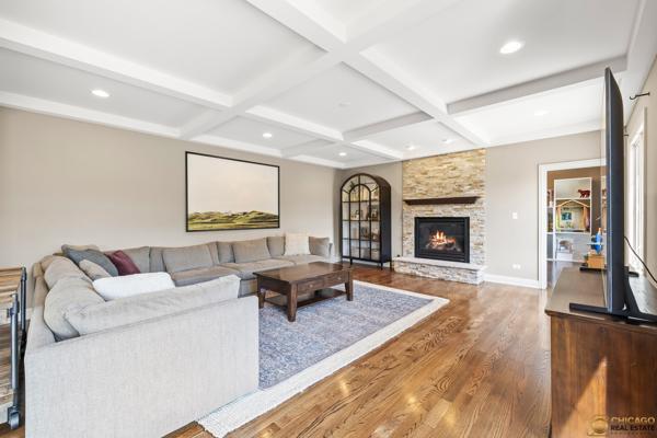 13119 Kinsale Ct, Lemont, IL 60439 - living room featuring wood finished floors, beamed ceiling, a stone fireplace, coffered ceiling, and recessed lighting