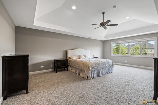 13119 Kinsale Ct, Lemont, IL 60439 - carpeted bedroom featuring a raised ceiling, recessed lighting, and ceiling fan