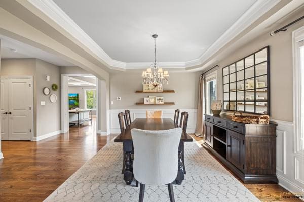 13119 Kinsale Ct, Lemont, IL 60439 - dining room featuring a chandelier, plenty of natural light, wood finished floors, ornamental molding, and arched walkways