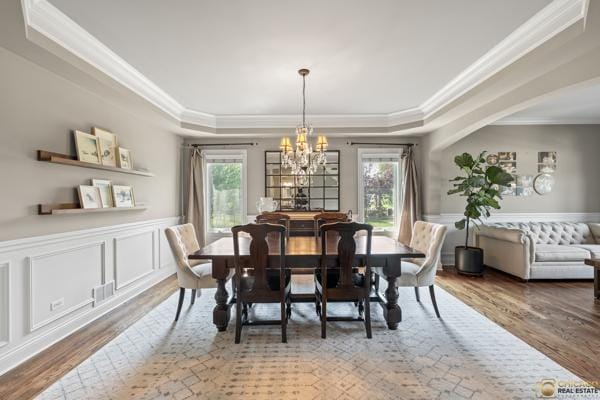 13119 Kinsale Ct, Lemont, IL 60439 - dining room with a raised ceiling, healthy amount of natural light, a chandelier, wood finished floors, and ornamental molding