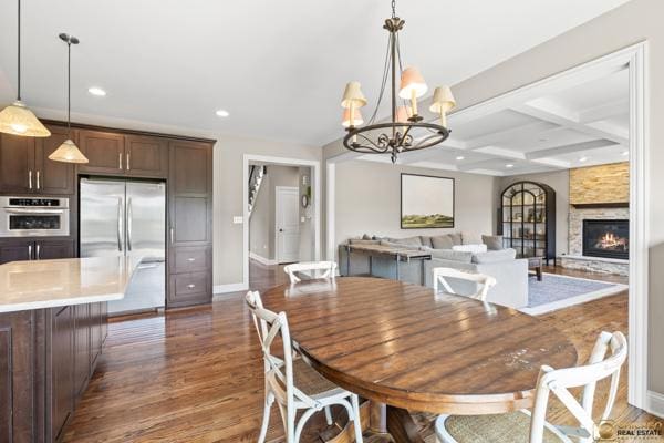 13119 Kinsale Ct, Lemont, IL 60439 - dining space with a chandelier, dark wood-style floors, recessed lighting, beamed ceiling, and a stone fireplace