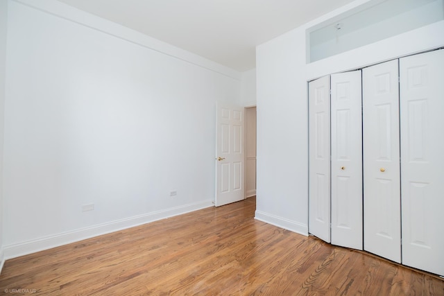 4536 N Sheridan Rd Unit 104, Chicago, IL 60640 - unfurnished bedroom with light wood-style flooring and a closet