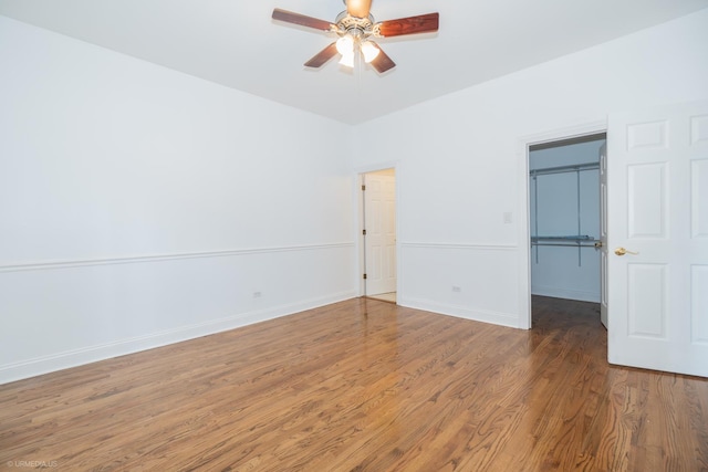 4536 N Sheridan Rd Unit 104, Chicago, IL 60640 - unfurnished bedroom featuring a walk in closet, wood finished floors, a closet, and ceiling fan