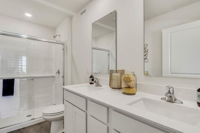 4944 Yates Dr Unit 0074, Mount Pleasant, WI 53403 - full bath featuring a stall shower, double vanity, and wood finished floors