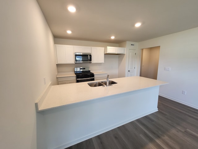 4944 Yates Dr Unit 0074, Mount Pleasant, WI 53403 - kitchen with appliances with stainless steel finishes, white cabinetry, dark wood-type flooring, light countertops, and recessed lighting