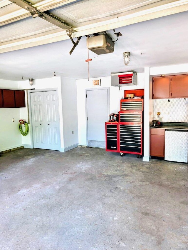 2303 Sumac Ct, Champaign, IL 61821 - garage featuring a garage door opener and a workshop area