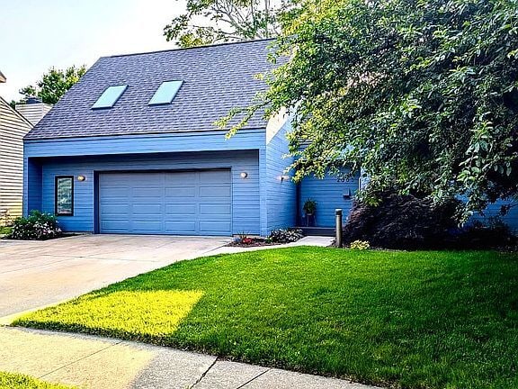 2303 Sumac Ct, Champaign, IL 61821 - view of front of home featuring a front yard, driveway, roof with shingles, and a garage