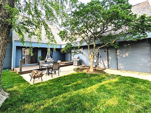 2303 Sumac Ct, Champaign, IL 61821 - back of house with a patio, a lawn, and a shingled roof