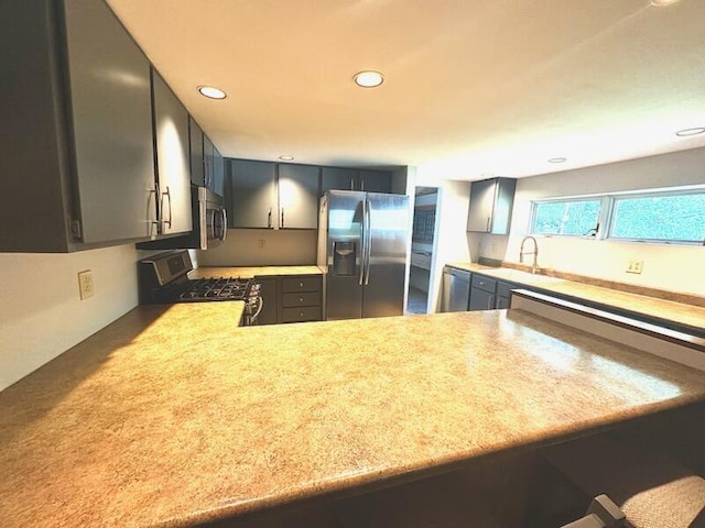 2303 Sumac Ct, Champaign, IL 61821 - kitchen featuring stainless steel appliances, light countertops, recessed lighting, gray cabinets, and a peninsula