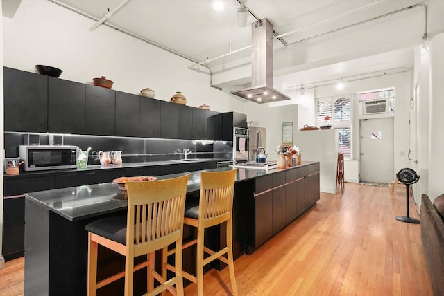 727 S Dearborn St Unit 311, Chicago, IL 60605 - kitchen with track lighting, appliances with stainless steel finishes, dark cabinetry, dark countertops, and modern cabinets