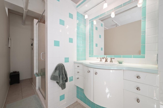 727 S Dearborn St Unit 311, Chicago, IL 60605 - bathroom featuring tile walls, a stall shower, vanity, and tile patterned flooring