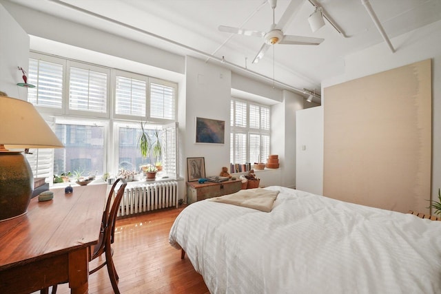 727 S Dearborn St Unit 311, Chicago, IL 60605 - bedroom with radiator heating unit, rail lighting, and hardwood / wood-style floors