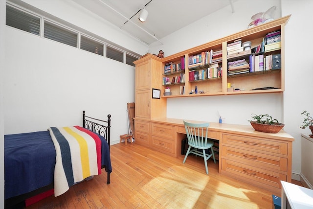 727 S Dearborn St Unit 311, Chicago, IL 60605 - bedroom featuring built in desk, light wood-type flooring, and track lighting