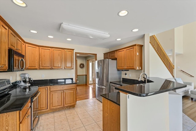 3220 Weeping Cherry Dr, Champaign, IL 61822 - kitchen with stainless steel appliances, a peninsula, recessed lighting, light tile patterned floors, and brown cabinets
