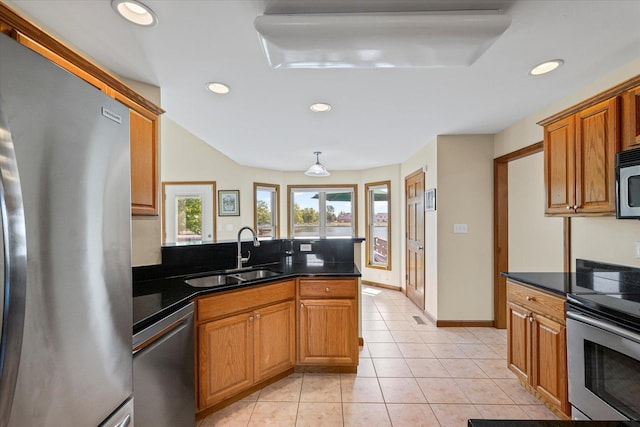 3220 Weeping Cherry Dr, Champaign, IL 61822 - kitchen with appliances with stainless steel finishes, recessed lighting, light tile patterned floors, brown cabinets, and a peninsula