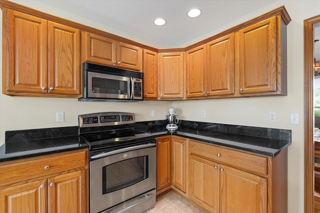 3220 Weeping Cherry Dr, Champaign, IL 61822 - kitchen with appliances with stainless steel finishes, brown cabinets, recessed lighting, dark stone countertops, and light tile patterned floors