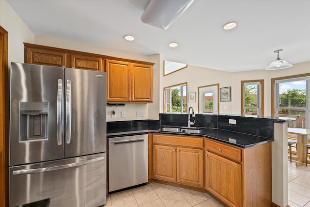 3220 Weeping Cherry Dr, Champaign, IL 61822 - kitchen with stainless steel appliances, a peninsula, light tile patterned floors, healthy amount of natural light, and recessed lighting