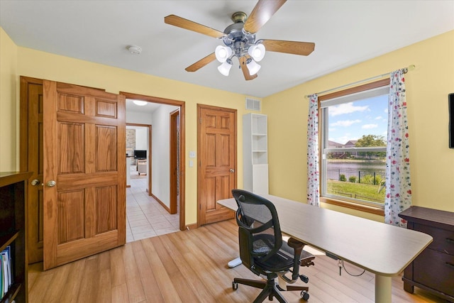3220 Weeping Cherry Dr, Champaign, IL 61822 - home office with light wood-style floors and a ceiling fan