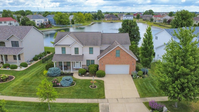 3220 Weeping Cherry Dr, Champaign, IL 61822 - view of front facade with concrete driveway, a porch, a water view, and a residential view