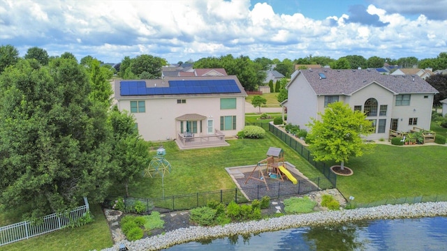 3220 Weeping Cherry Dr, Champaign, IL 61822 - rear view of property with a playground, a patio area, a fenced backyard, and roof mounted solar panels