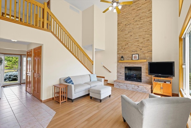 3220 Weeping Cherry Dr, Champaign, IL 61822 - living area with a high ceiling, stairway, wood finished floors, a fireplace, and a ceiling fan