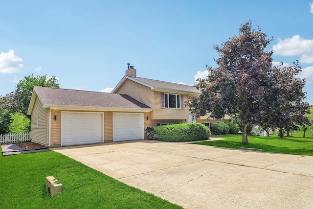 2642 N 3739th Rd, Sheridan, IL 60551 - tri-level home with an attached garage, a chimney, and concrete driveway