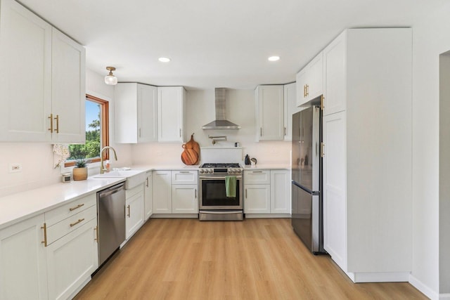 2642 N 3739th Rd, Sheridan, IL 60551 - kitchen with stainless steel appliances, wall chimney exhaust hood, light wood finished floors, white cabinets, and recessed lighting