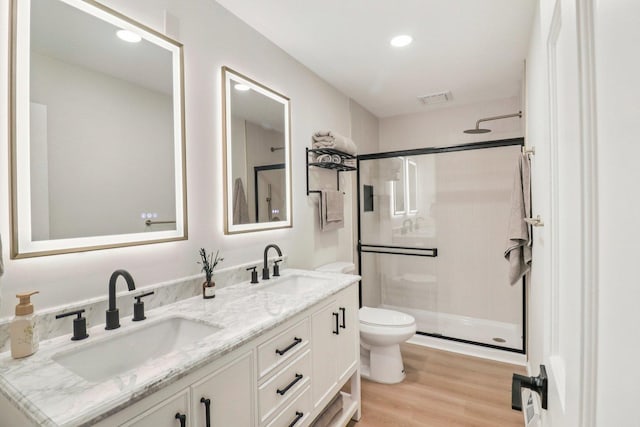 2642 N 3739th Rd, Sheridan, IL 60551 - bathroom featuring a shower stall, double vanity, wood finished floors, and recessed lighting