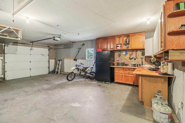 2642 N 3739th Rd, Sheridan, IL 60551 - garage featuring freestanding refrigerator, a workshop area, and a garage door opener