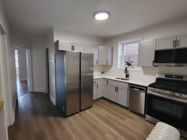 1623 S 58th Ct, Cicero, IL 60804 - kitchen featuring appliances with stainless steel finishes, light countertops, light wood-type flooring, and gray cabinetry