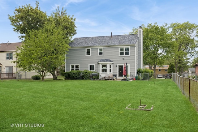 109 N Wilke Rd, Palatine, IL 60074 - rear view of house featuring a chimney, a fenced backyard, and roof with shingles