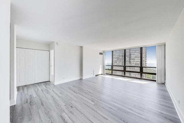 1636 N Wells St Unit 3007, Chicago, IL 60614 - unfurnished living room featuring wood finished floors and floor to ceiling windows