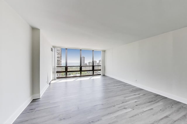1636 N Wells St Unit 3007, Chicago, IL 60614 - spare room with floor to ceiling windows, wood finished floors, and a city view