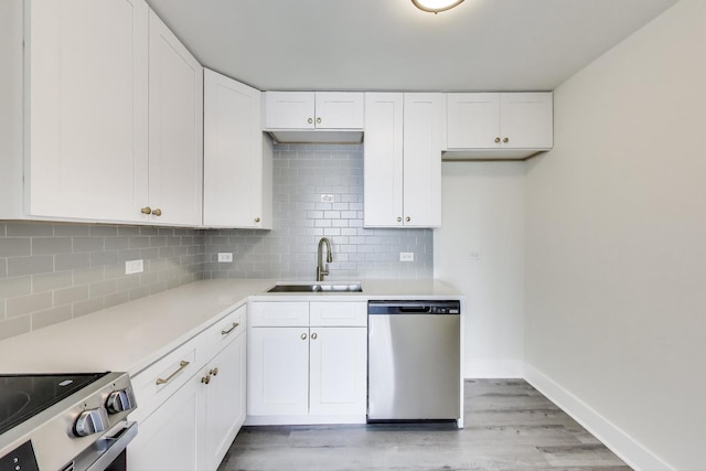 1636 N Wells St Unit 3007, Chicago, IL 60614 - kitchen featuring appliances with stainless steel finishes, white cabinetry, light wood-style flooring, light countertops, and decorative backsplash
